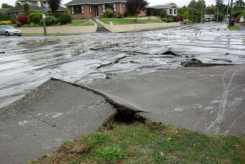 IMGP5756.jpg - On the 22nd of February we had another earthquake, much more destructive than the one from the previous September.  The damage in our neighbourhood was limited compared to the eastern and central areas of the city which were hit very hard.  I had been in the CBD at the time and was very lucky to come out alive.The water and mud you see here were brought up by the process of liquefaction which was caused by the ground shaking.  In addition, water and sewer pipes were ruptured so we had to boil our drinking water and be careful around any puddles.  A water main running through this intersection had to be repaired several times during the following months.We ended up working from home for a week or two until a temporary office could be arranged as our normal office was with in the CBD cordon - where it remains to this day.  The owner of the company was extremely fortunate that someone was able to retrieve essential items from the office.