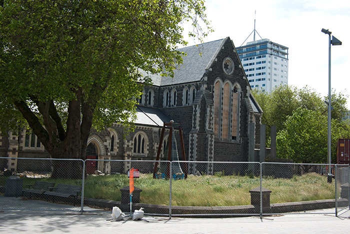 IMGP6669.jpg - Side view of the Cathedral with a spire on the unkempt lawn.  The tower in the background is OK (unfortunately... I think it's ugly).