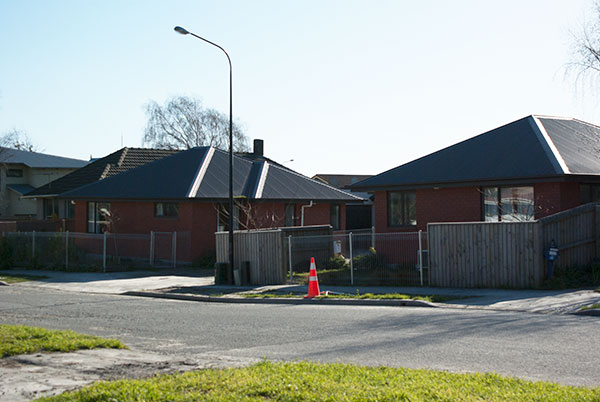 IMGP6365.jpg - The left house is tilted due to liquefaction unevenly undermining the foundation... which is fairly common among houses on this street.  They may be able to re-level it, if not it'll have to come down.